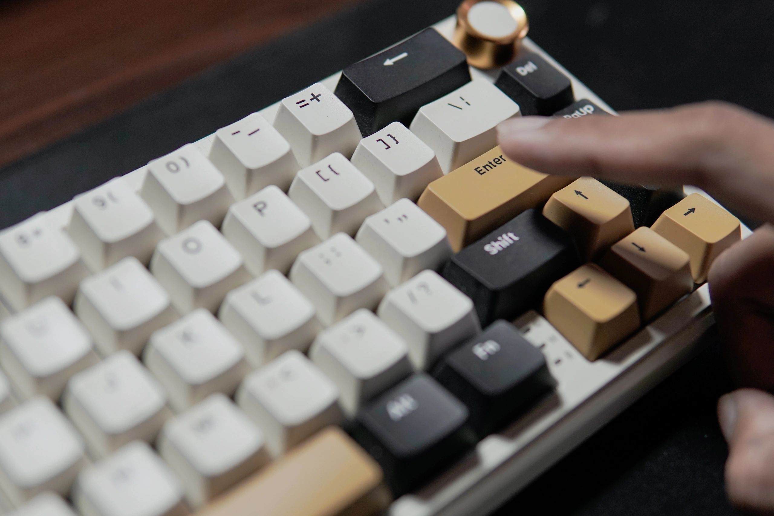 Finger pressing the Enter key on a mechanical keyboard