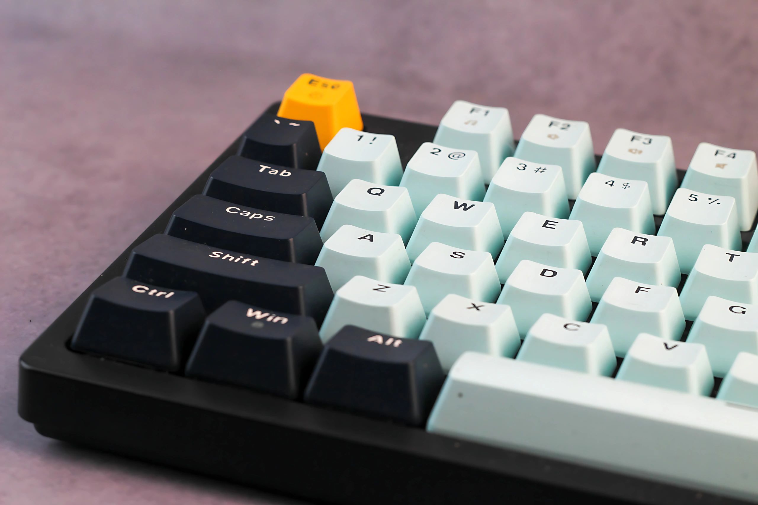 Close-up of mechanical keyboard keycaps with a bright accent key